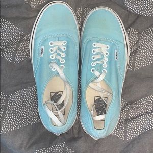 A pair of baby blue vans